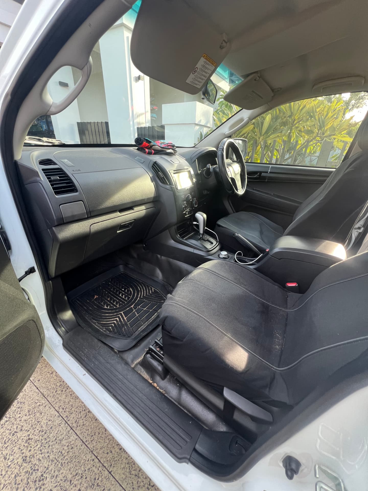 Dusty ute cabin before detailing with dirty floor mats and carpets