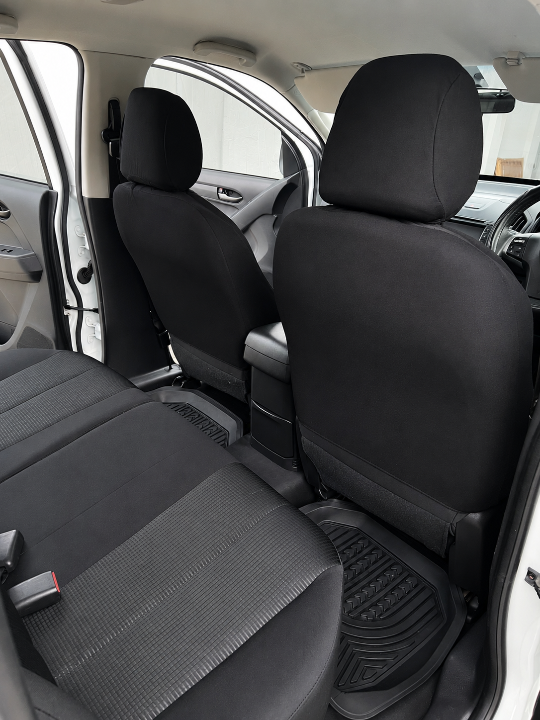 Freshly detailed ute rear seats with clean fabric trim and rubber floor mats