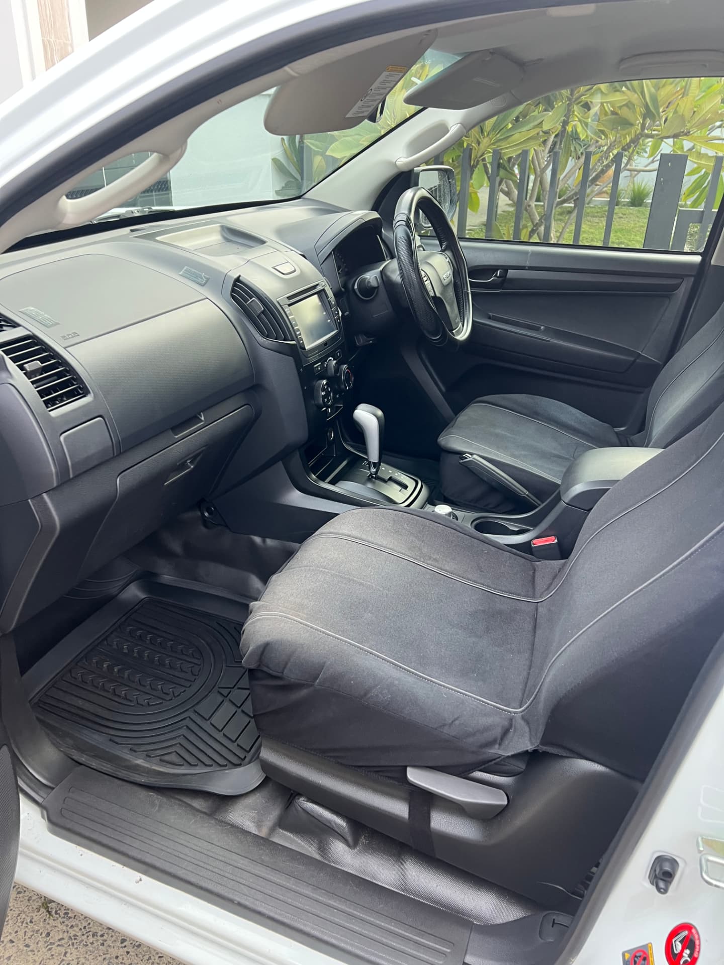 Clean dual-cab ute interior with vacuumed carpets, mats and detailed dashboard